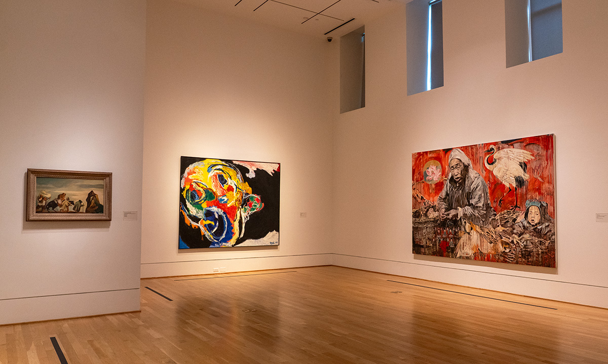 Installation view of one small and two large paintings