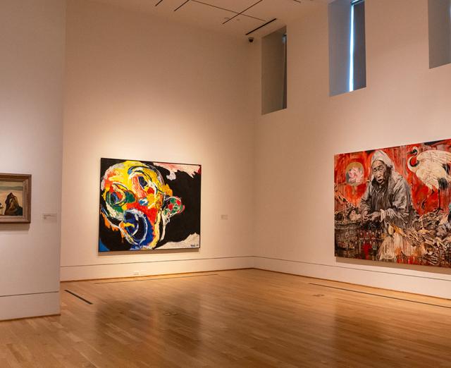 Installation view of one small and two large paintings