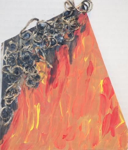 An orange, yellow, and red fire with gray yarn above it.