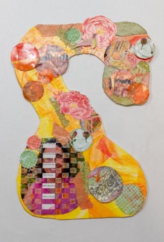 A snake-shaped collage with orange and yellow paper pieces.