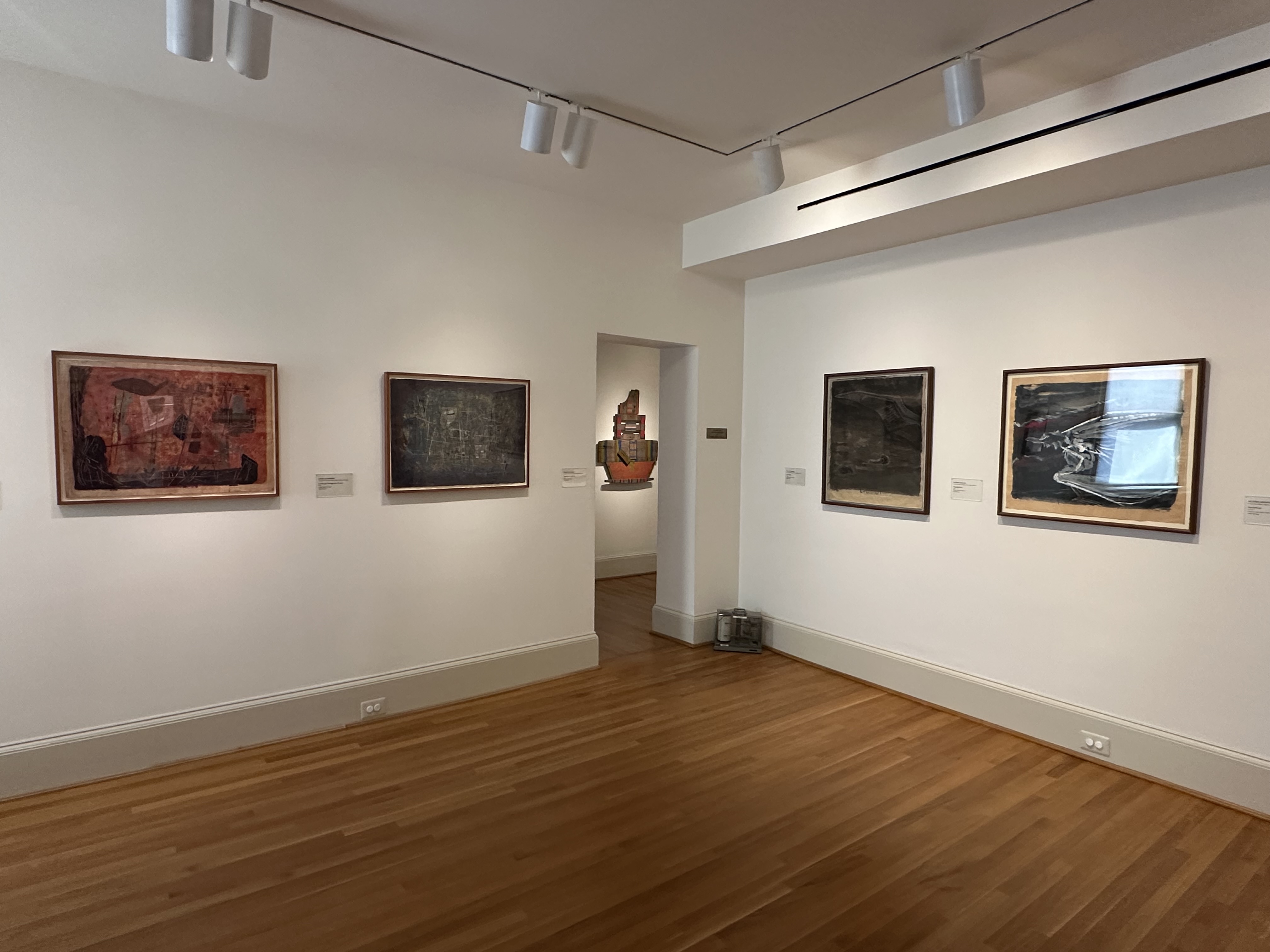 Installation photo of Gallery C with 4 artworks on the wall and an artwork in the doorway in Gallery D