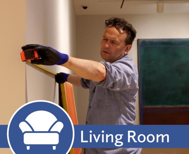 Living Room promo image with Alec measuring a wall