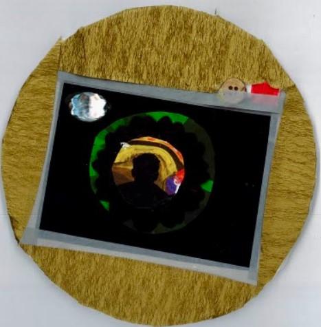 Circle with collage of an image of a dark tunnel surrounded by yellow fabric.