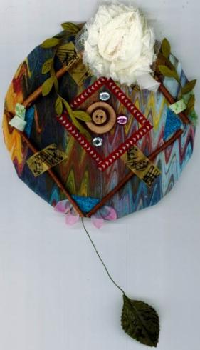 Circle with collage of an abstract design with leaves and one leaf stemming out from the bottom.