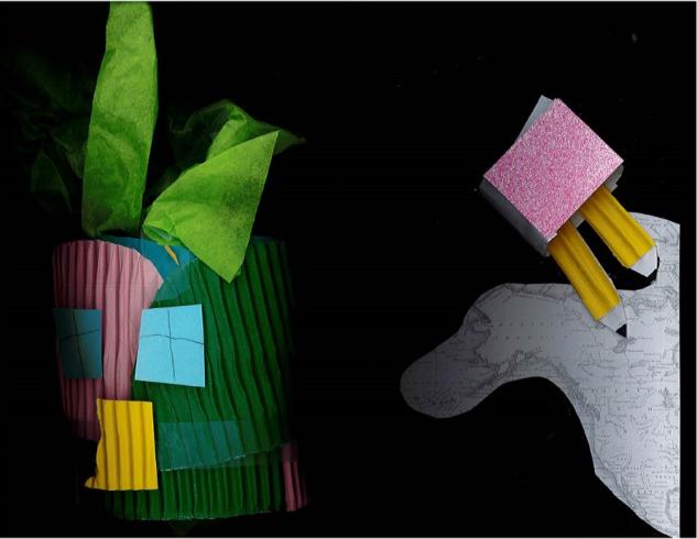 Paper collage with a green structure and two pencils drawing a map.