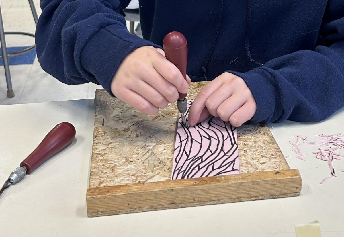Photograph of student making a print