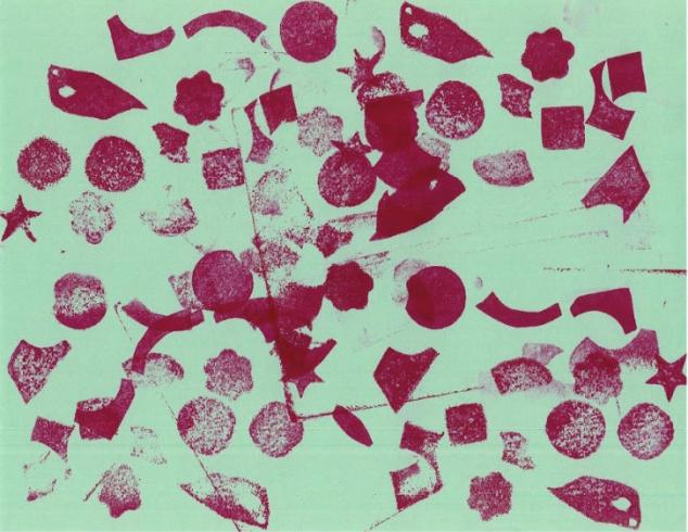 Pink stamped pattern on light green paper.