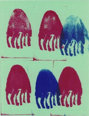 Pink and blue jellyfish stamped on green paper.