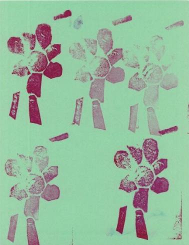 Pink flower pattern stamped on green paper.