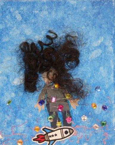 Painted canvas with gems and a person with long hair.