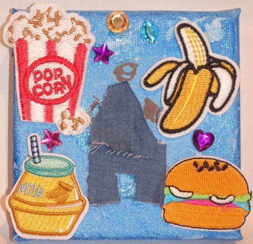 Painted canvas with food stickers and gems.