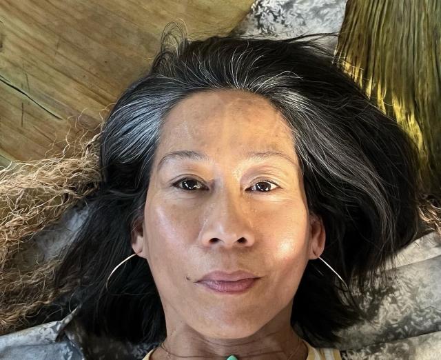 Photograph of Tina Villadolid laying on the ground