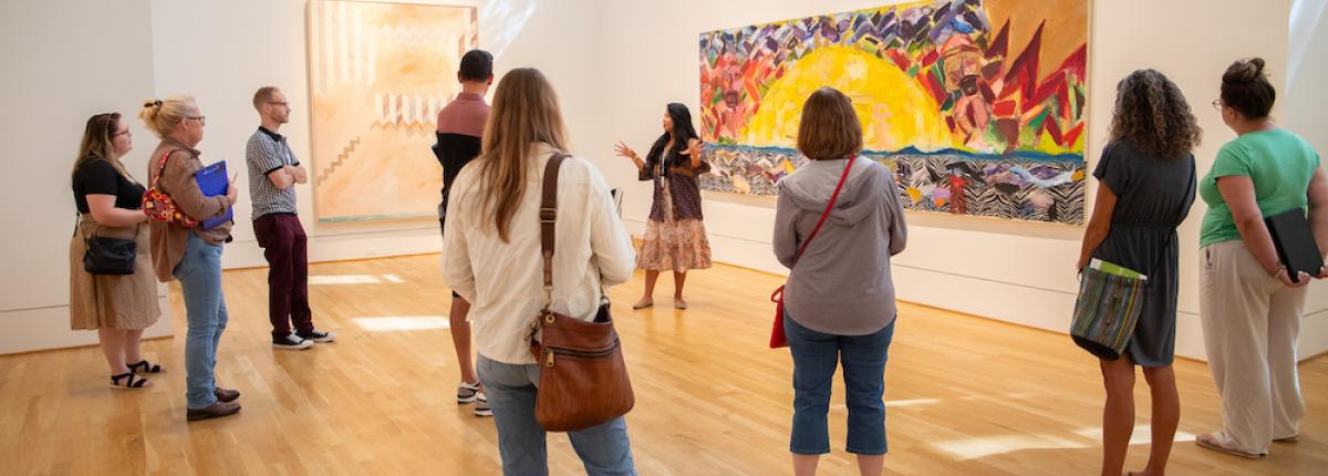 Educators observing a large painting, led by a Phillips educator 