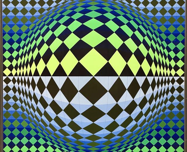 Optical artwork with geometric shapes in greens, blues, black, and white